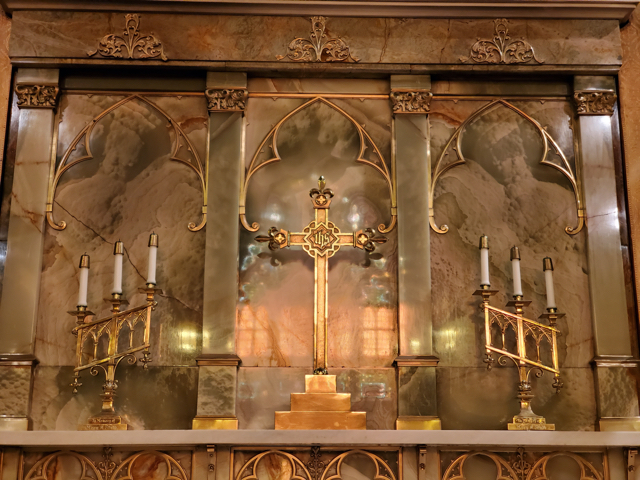 The cross and candles on the altar
