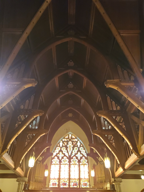 The nave vaulted ceiling, featuring beautiful woodwork including cherubs.