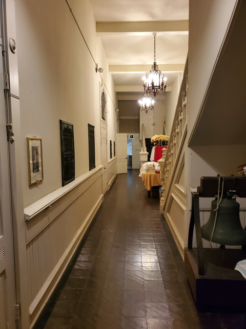 The hallway between the Sanctuary and Fellowship Hall, where many historical plaques are featured.